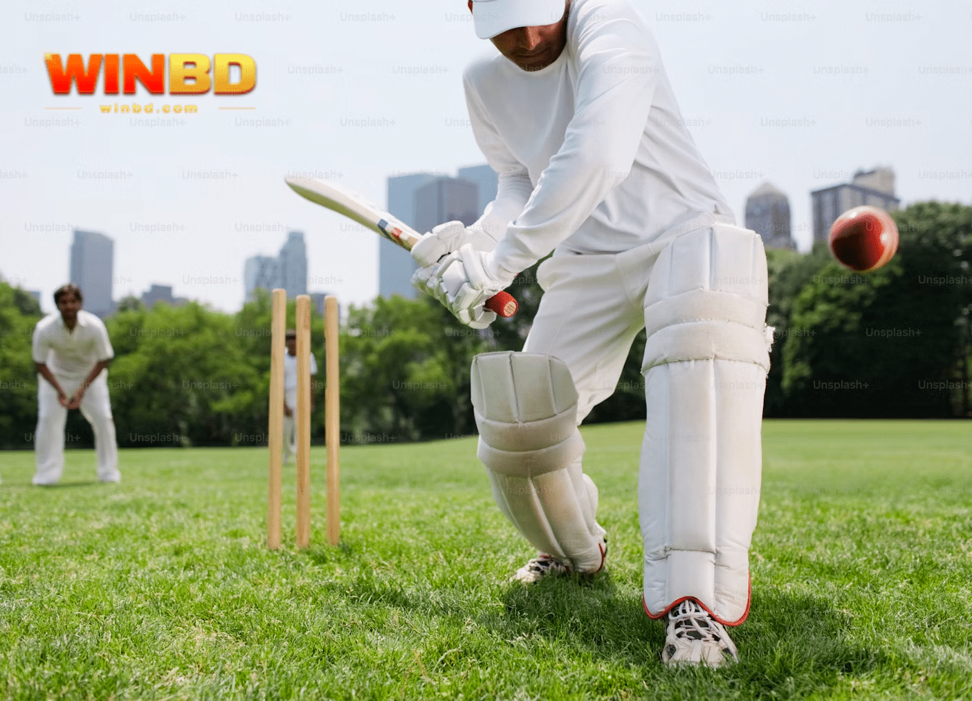 a man in white playing cricket