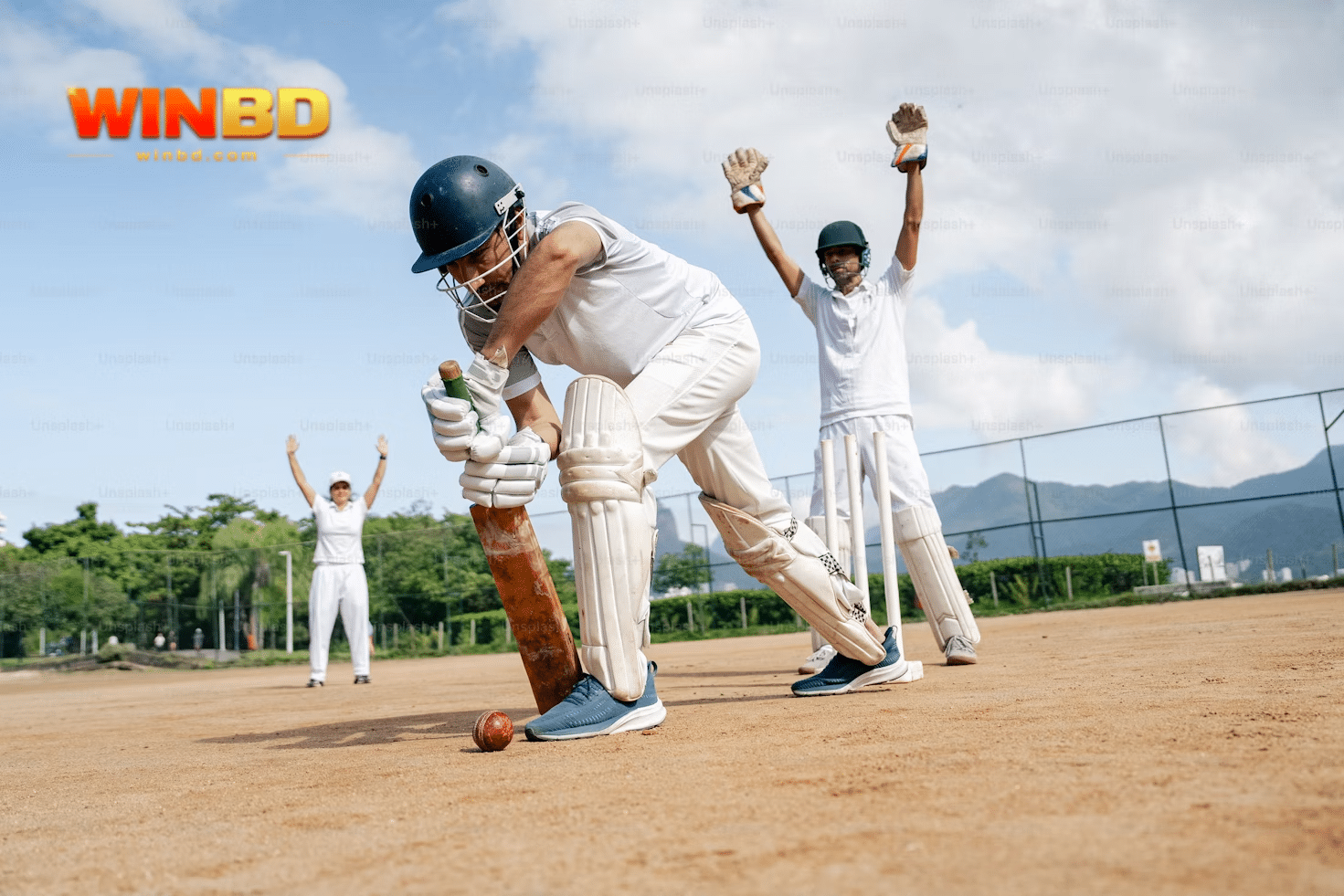 a group of people in white uniforms playing cricket